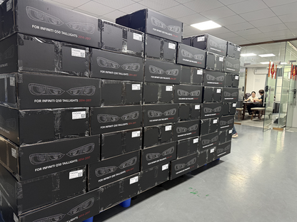 Stacks of black automotive headlight boxes inside a warehouse