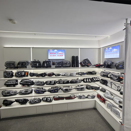 Automotive lights displayed around a white showroom wall